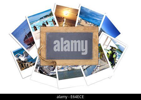 Old slate blackboard with blank write space lies on a stack of many Vacations instant pictures isolated on white Background Stock Photo