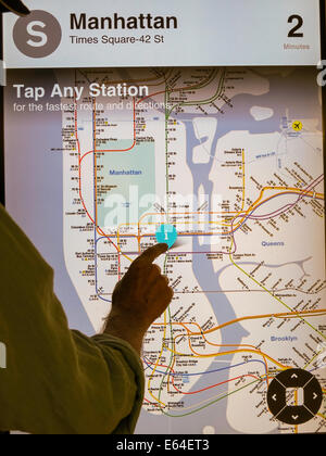 Silhouette of Rider in front of Illuminated MTA Subway Map, NYC Stock Photo