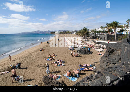 playa grande Lanzarote beach beaches sun lounger loungers sunlounger sunloungers sun bathing sunbathers sunbathe bathe sand sand Stock Photo