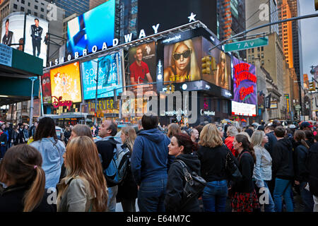 Crowd of people walking in the Times Square at dusk. New York, USA. Stock Photo