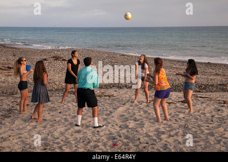 Young adults playing volley ball on the beach, Dana Point, California, USA Stock Photo