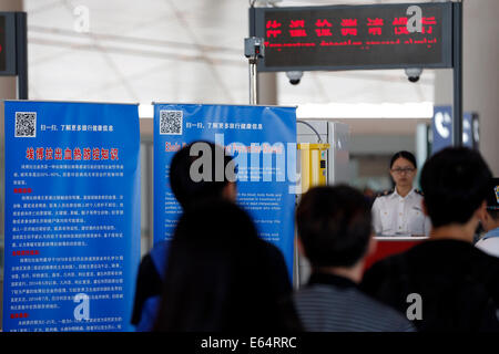 Beijing, China. 14th Aug, 2014. Billboards about prevent Ebola virus disease are seen at the Beijing Capital International Airport in Beijing, capital of China, Aug. 14, 2014. To prevent the deadly Ebola virus from entering China, China's quarantine authority implements stricter inspections on inbound flights from regions affected by Ebola and step up sanitary measures on incoming goods. Credit:  Shen Bohan/Xinhua/Alamy Live News Stock Photo