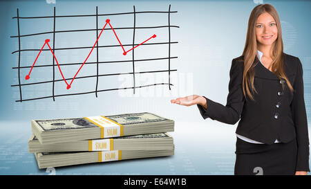 Businesswoman points hand on packs dollars Stock Photo