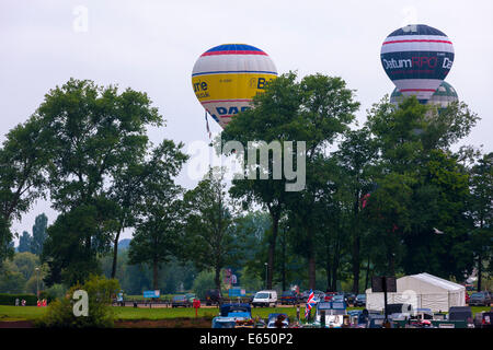 Northampton, UK. 15th Aug, 2014. The 25th Northampton Balloon festival. The Sixth held at Billing Aquadrome. The first morning flight  of the three day event. With low cloud and dampish weather the balloonists struggled to clear the trees and gain height . Credit:  Keith J Smith./Alamy Live News Stock Photo