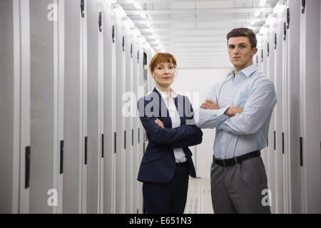 Team of computer technicians looking at camera Stock Photo