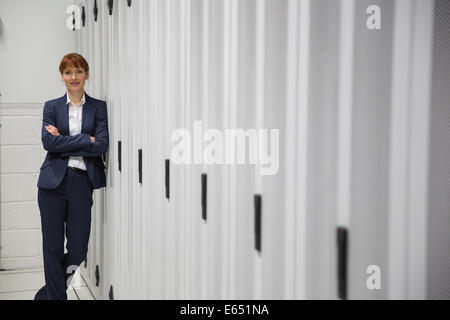 Pretty computer technician looking at camera Stock Photo