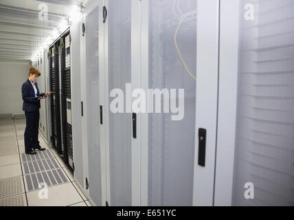 Technician working on servers using tablet pc Stock Photo