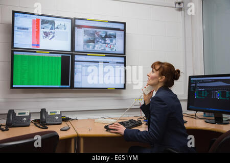 Technician sitting in office running diagnostics Stock Photo