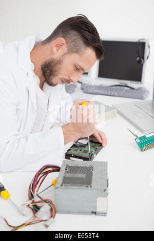 Computer engineer working on broken cpu with screwdriver Stock Photo