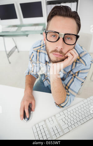 Nerdy bored businessman working on computer Stock Photo