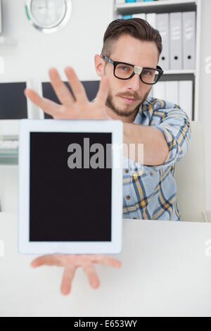 Nerdy businessman showing tablet pc screen Stock Photo