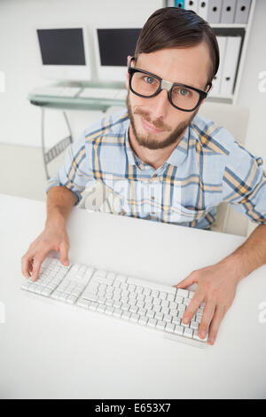 Nerdy businessman working on computer Stock Photo
