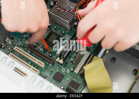Technician working on broken cpu with soldering iron Stock Photo