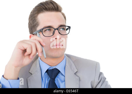 Nerdy businessman holding pen looking away Stock Photo