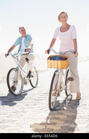Happy senior couple going for a bike ride Stock Photo