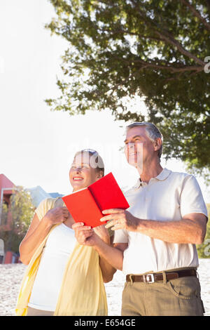 Happy senior couple using the guidebook Stock Photo