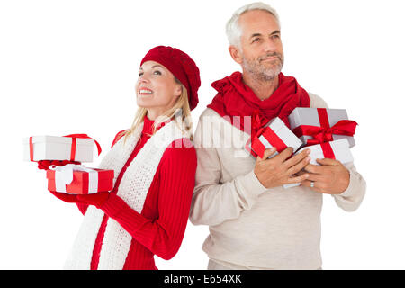 Smiling couple in winter fashion holding presents Stock Photo