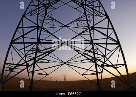 Electricity pylons at sunset, france Stock Photo
