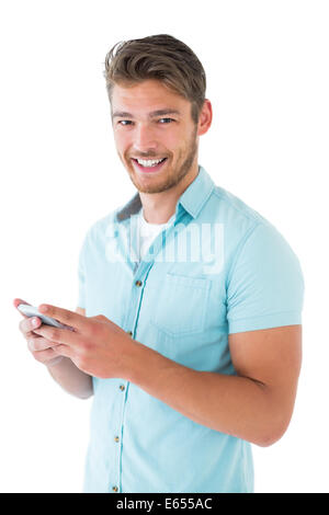Handsome young man using his smartphone Stock Photo