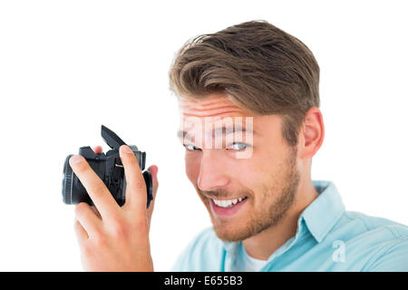 Handsome young man holding digital camera Stock Photo