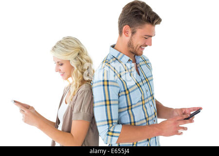 Attractive couple using their smartphones Stock Photo