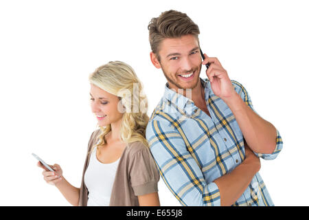 Attractive couple using their smartphones Stock Photo