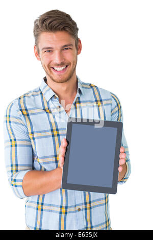 Handsome young man with tablet isolated in studio Stock Photo - Alamy