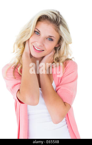 Pretty blonde wearing a pink cardigan, smiling Stock Photo - Alamy