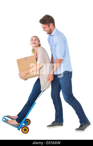 Young couple having fun on moving trolley Stock Photo