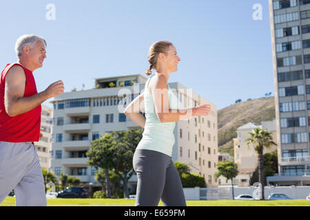 Fit mature couple jogging together Stock Photo
