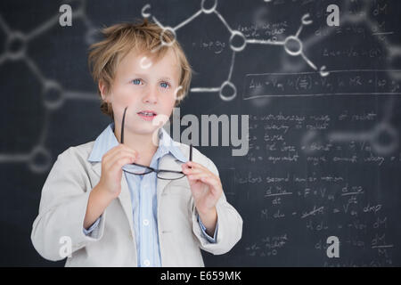 Composite image of cute pupil holding glasses Stock Photo