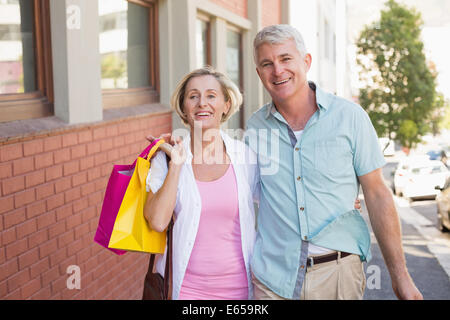 Happy mature couple walking with their shopping purchases Stock Photo