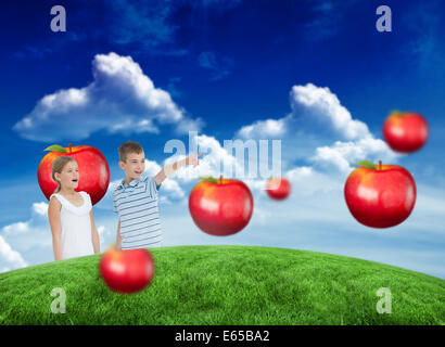 Composite image of young boy showing something to his sister Stock Photo