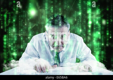 Composite image of mature businessman typing on keyboard Stock Photo