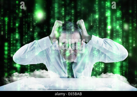 Composite image of stressed businessman using a keyboard Stock Photo
