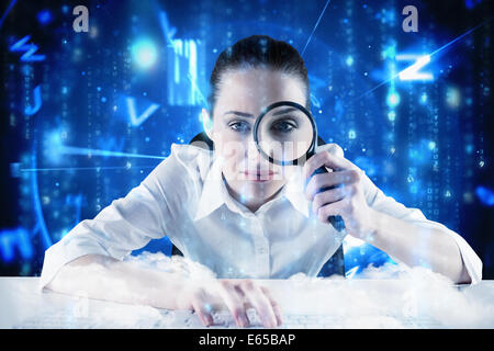Composite image of businesswoman typing and looking through magnifying glass Stock Photo