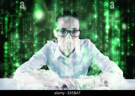 Composite image of businesswoman typing on a keyboard Stock Photo