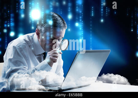 Composite image of mature businessman examining with magnifying glass Stock Photo