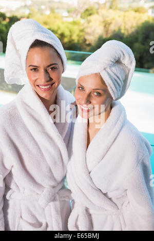 Smiling young women in bathrobes Stock Photo
