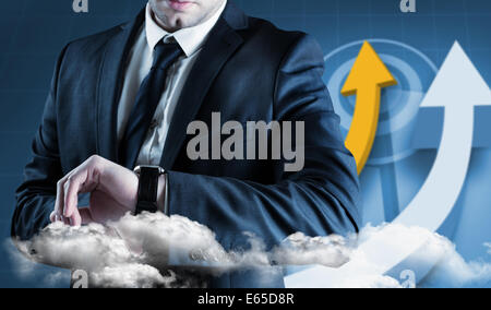 Composite image of businessman checking the time on watch Stock Photo