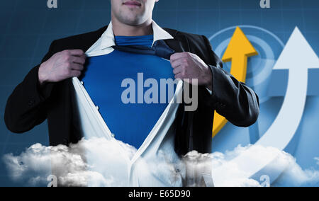 Composite image of businessman opening his shirt superhero style Stock Photo