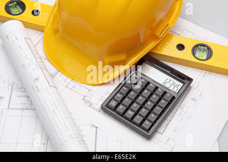 Blueprint, architecture model and pocket calculator in the close-up. Stock Photo