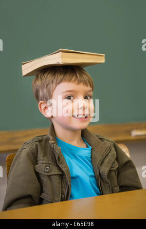 Boy balancing a book on his head Stock Photo - Alamy