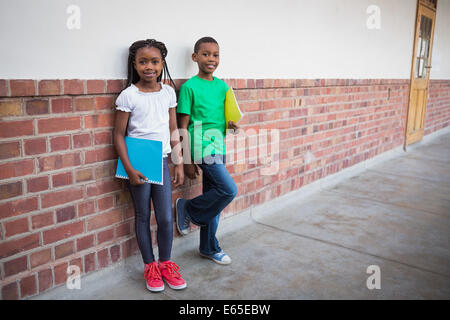 Cute pupils smiling at camera in classroom Stock Photo - Alamy