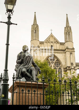 A low-angle view of the Robert Burns statue and St. Paul's Cathedral, from the Octagon, Dunedin, New Zealand Stock Photo