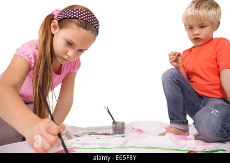 Happy little children painting on the floor Stock Photo