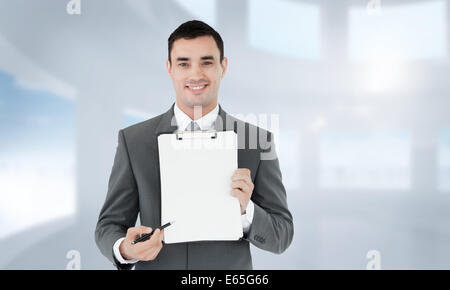 Composite image of businessman pointing with pen on clipboard Stock Photo