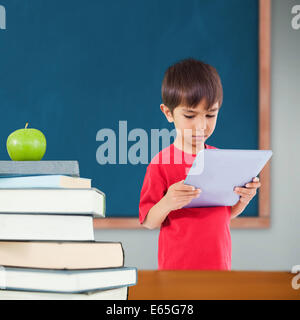 Composite image of cute boy using tablet Stock Photo