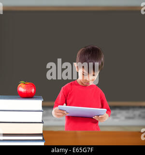Composite image of cute boy using tablet Stock Photo
