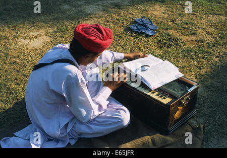 Sikh boy playing harmonium in the compound of a 'gurudwara' ( a sikh temple) ( India) Stock Photo